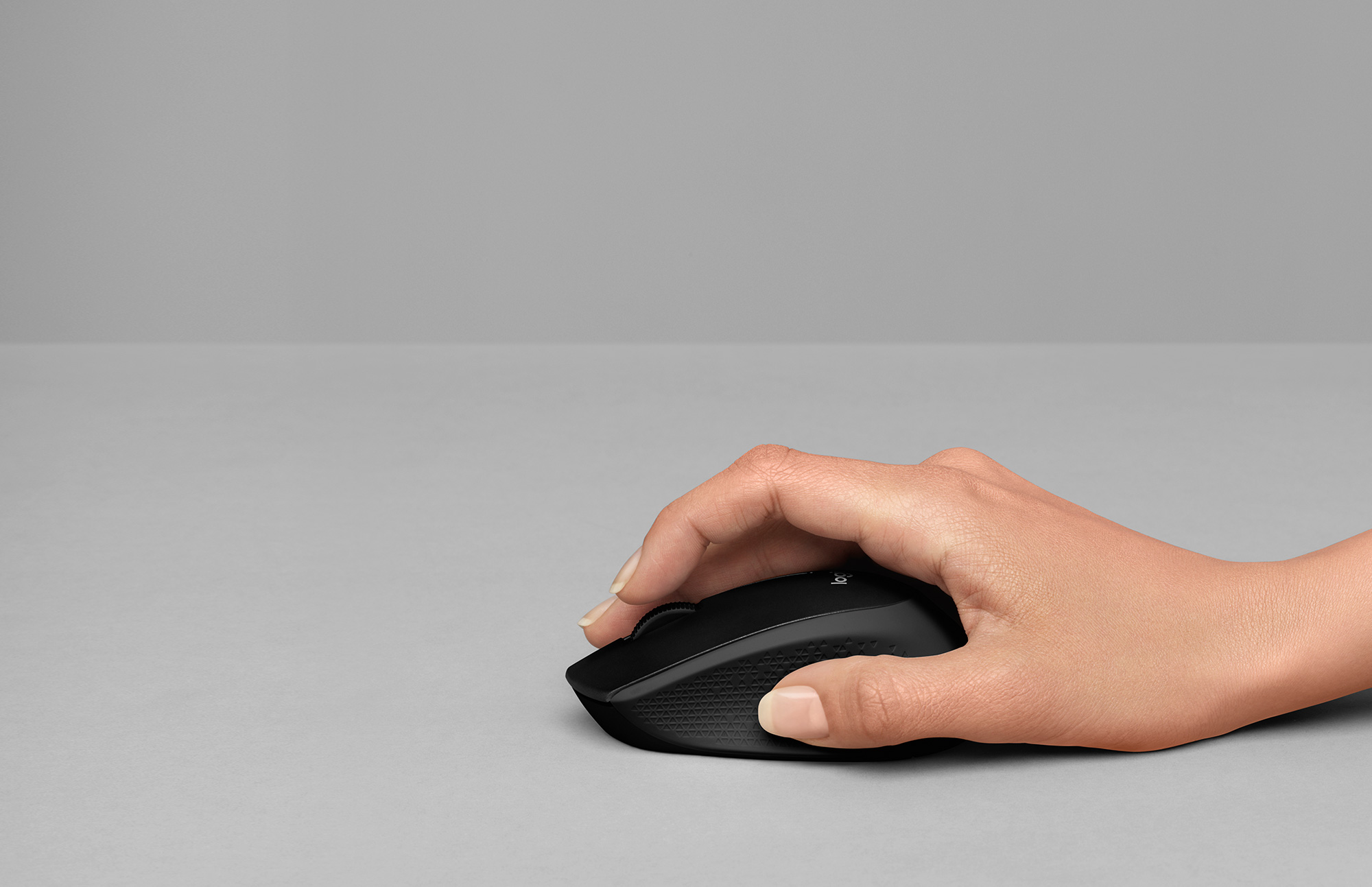 Hand holding M330 mouse