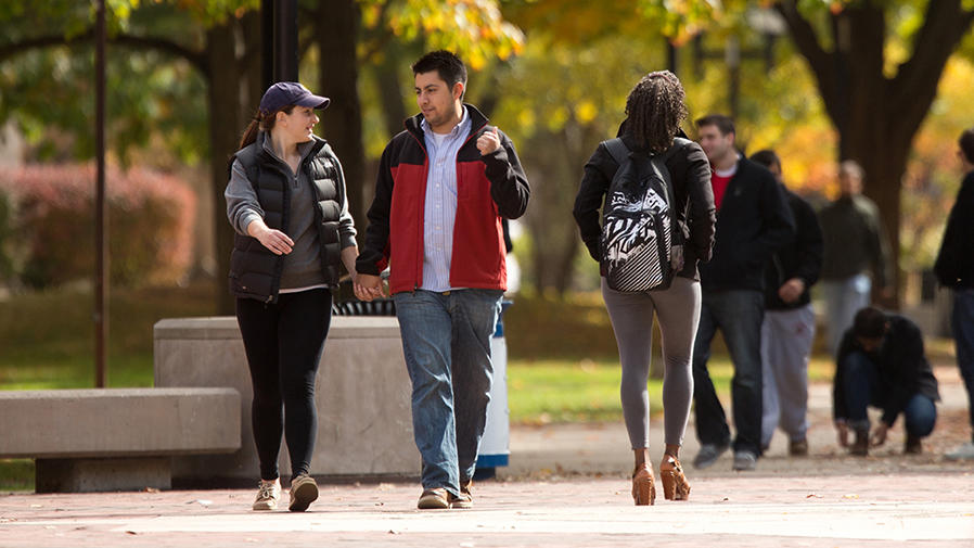 A couple walking together on campus